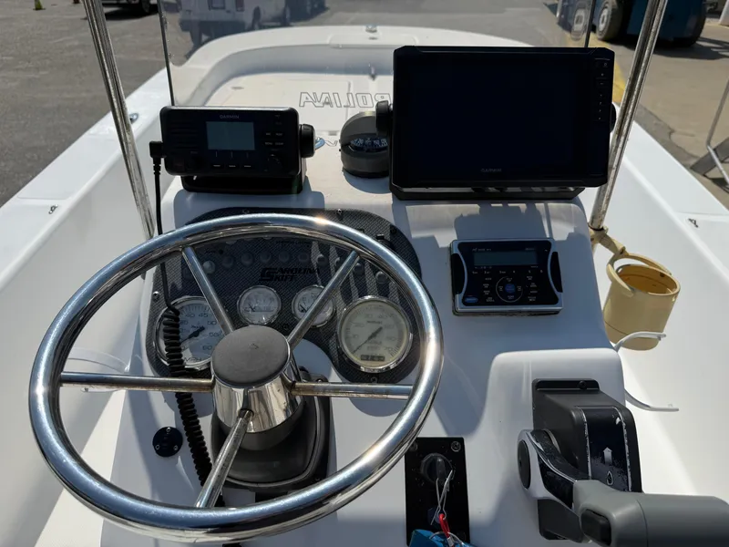 Slide: The Image of Steering console of a 2010 Carolina Skiff 218 ELV with navigation equipment and controls. - 10
