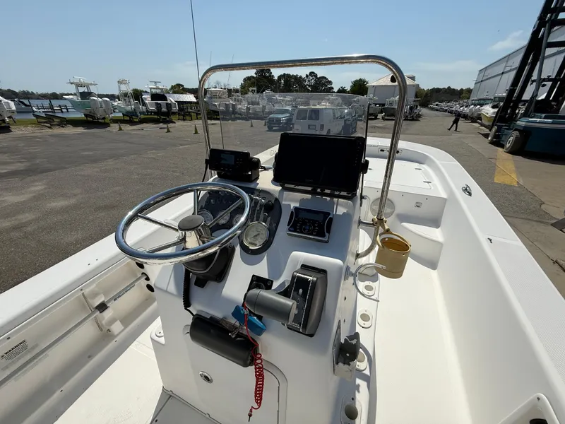 Slide: The Image of 2010 Carolina Skiff 218 ELV boat console with steering wheel and navigation equipment. - 12