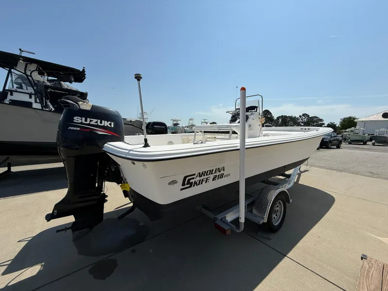 Slide: The Image of 2010 Carolina Skiff 218 ELV boat with Suzuki outboard motor on trailer. - 4