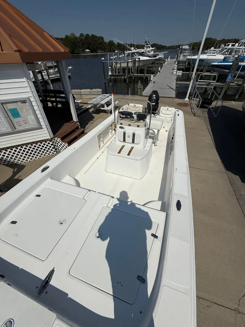 Slide: The Image of 2010 Carolina Skiff 218 ELV boat docked at marina, sunny day. - 8