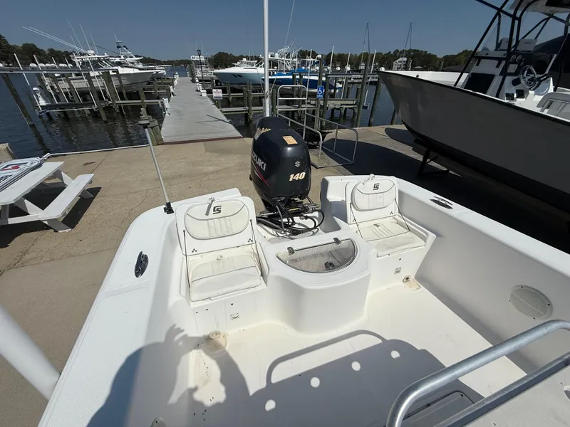 Slide: The Image of 2010 Carolina Skiff 218 ELV boat with Suzuki 140 engine at dock. - 9