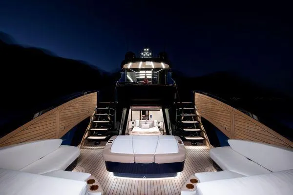 Slide: The Image of Luxurious 2023 Lazzara LSX yacht deck at night with elegant seating and ambient lighting. - 9