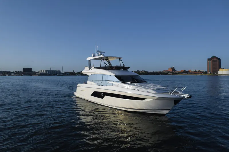 Slide: The Image of 2023 Prestige 520 F-Line yacht cruising on calm waters under a clear blue sky. - 0