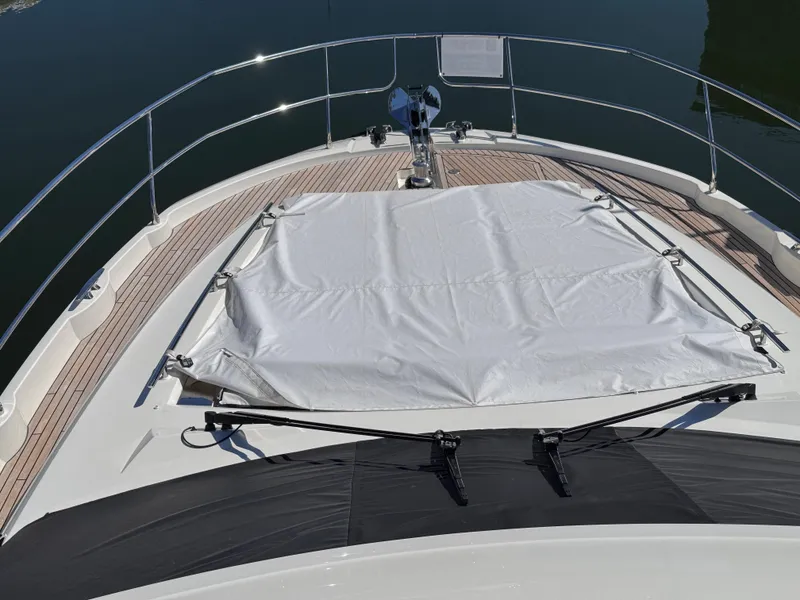 Slide: The Image of 2023 Prestige 520 F-Line yacht deck with sunbed cover and sleek railing design. - 15