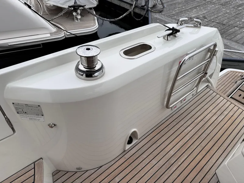 Slide: The Image of 2023 Prestige 520 F-Line yacht stern with winch and swim ladder on teak deck. - 20