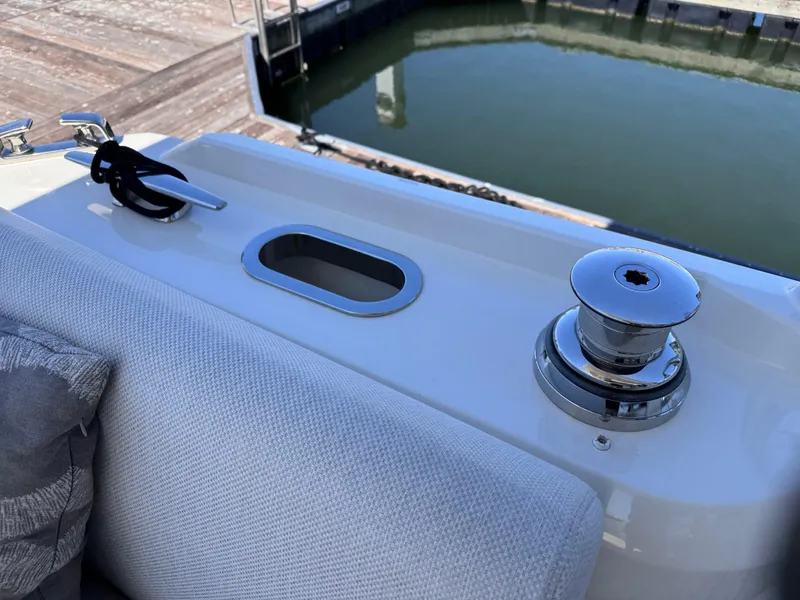 Slide: The Image of 2023 Prestige 520 F-Line yacht deck with cleat and winch by the water. - 21