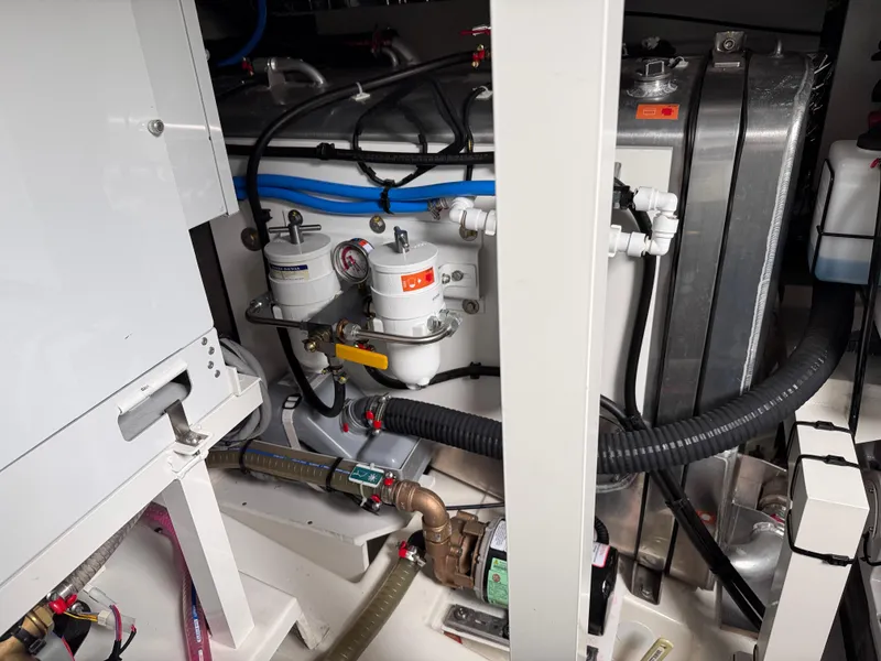 Slide: The Image of Engine room of 2023 Prestige 520 F-Line yacht, showcasing mechanical components and piping. - 24