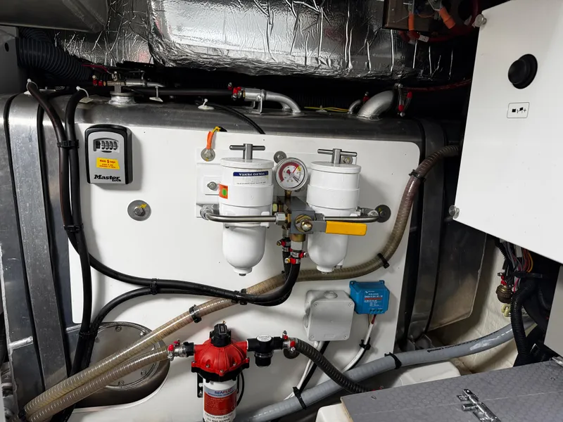 Slide: The Image of Engine room of 2023 Prestige 520 F-Line yacht, featuring fuel filters and mechanical components. - 25