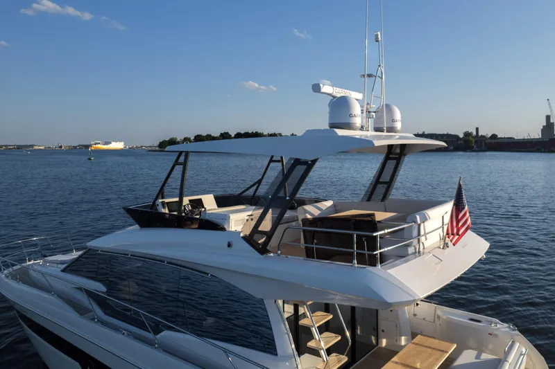 Slide: The Image of 2023 Prestige 520 F-Line yacht on calm water with clear sky. - 3