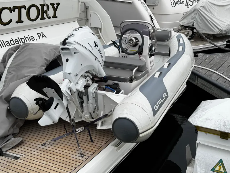 Slide: The Image of 2023 Prestige 520 F-Line yacht with attached Gala inflatable boat at dock. - 32