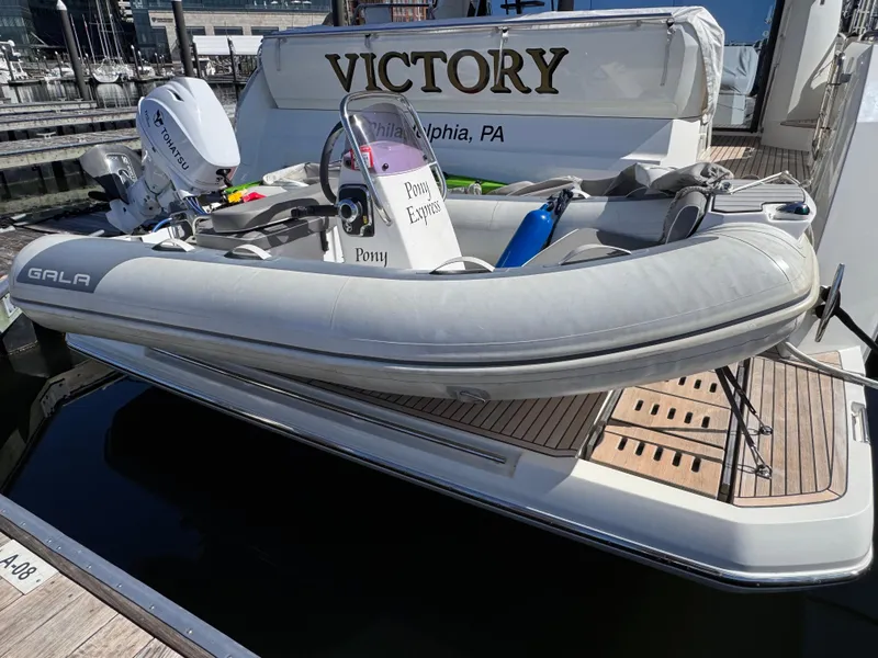 Slide: The Image of Prestige 520 F-Line yacht with inflatable boat, docked in Philadelphia, 2023 model. - 33