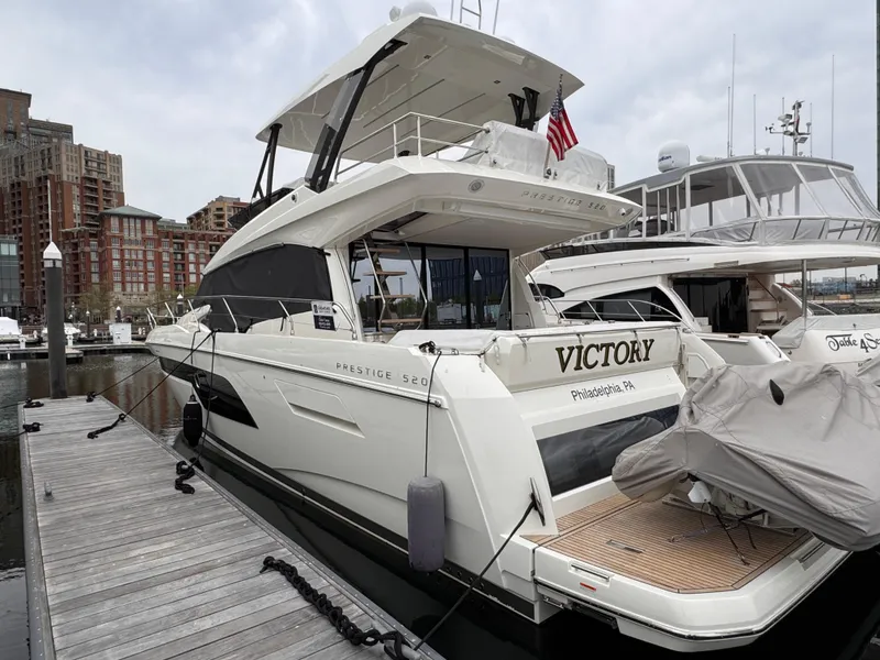 Slide: The Image of 2023 Prestige 520 F-Line yacht docked at marina, featuring sleek design and modern amenities. - 34