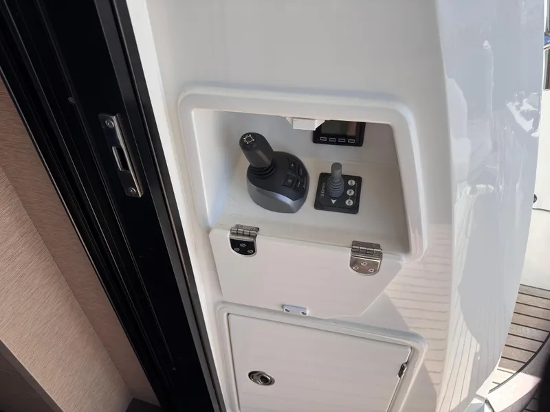Slide: The Image of Control panel on a 2023 Prestige 520 F-Line yacht, featuring joystick controls. - 37