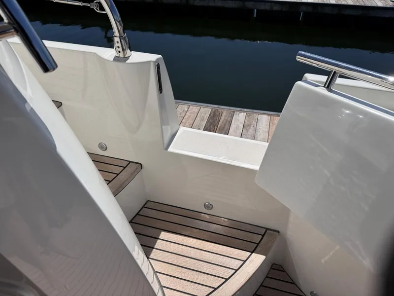 Slide: The Image of 2023 Prestige 520 F-Line yacht with sleek wooden steps and stainless steel railings. - 39