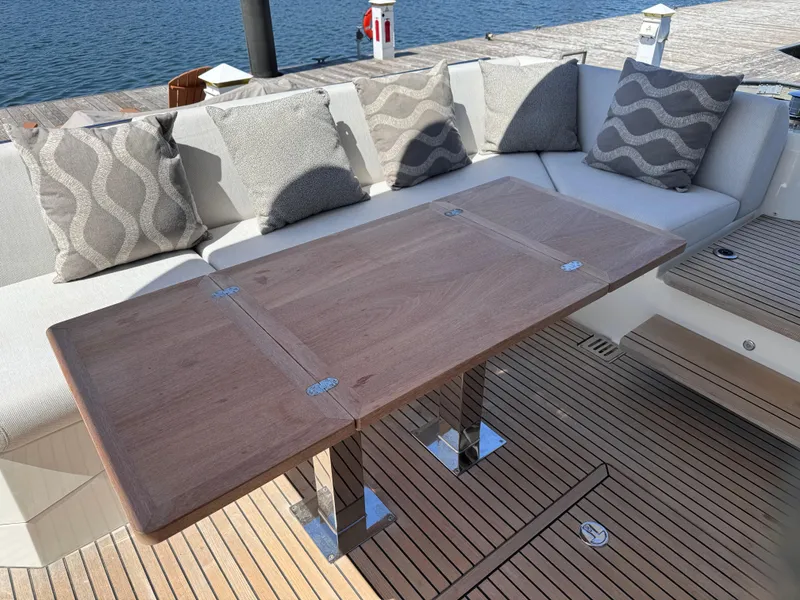 Slide: The Image of Luxurious seating area on 2023 Prestige 520 F-Line yacht with wooden table and cushions. - 42