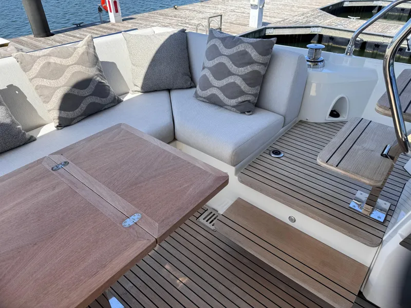 Slide: The Image of Luxurious seating area on 2023 Prestige 520 F-Line yacht with wooden table and cushions. - 43
