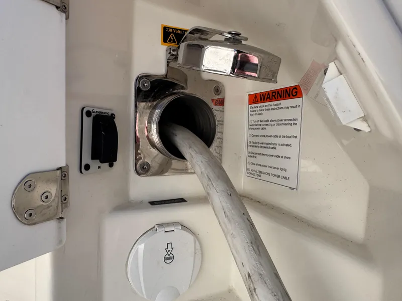 Slide: The Image of Fuel hose connected to a 2023 Prestige 520 F-Line yacht with warning labels visible. - 48