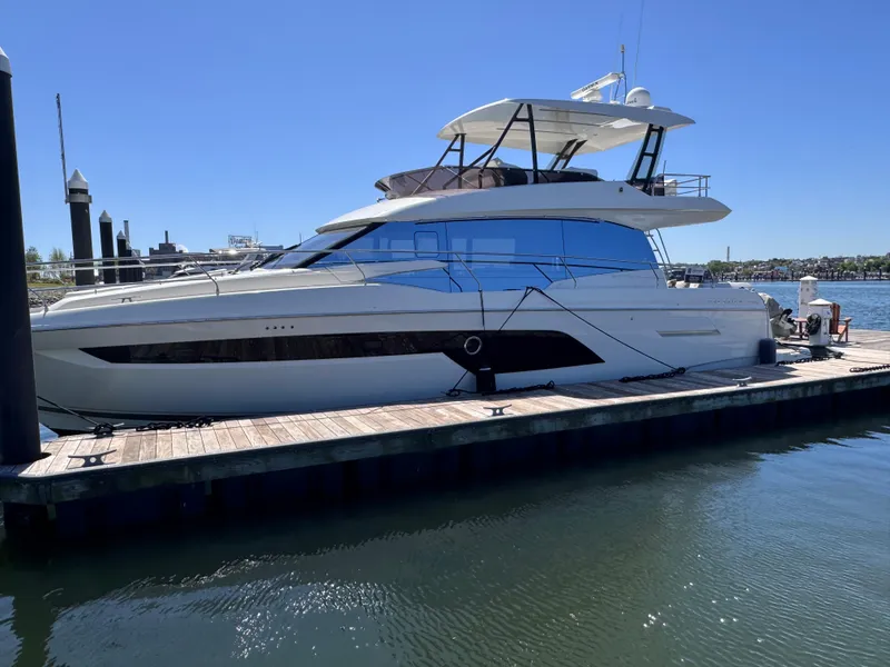 Slide: The Image of 2023 Prestige 520 F-Line yacht docked at marina under clear blue sky. - 5