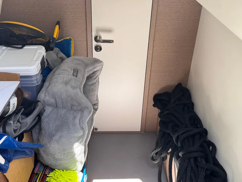 Slide: The Image of Storage area in a 2023 Prestige 520 F-Line yacht with various equipment and supplies. - 51