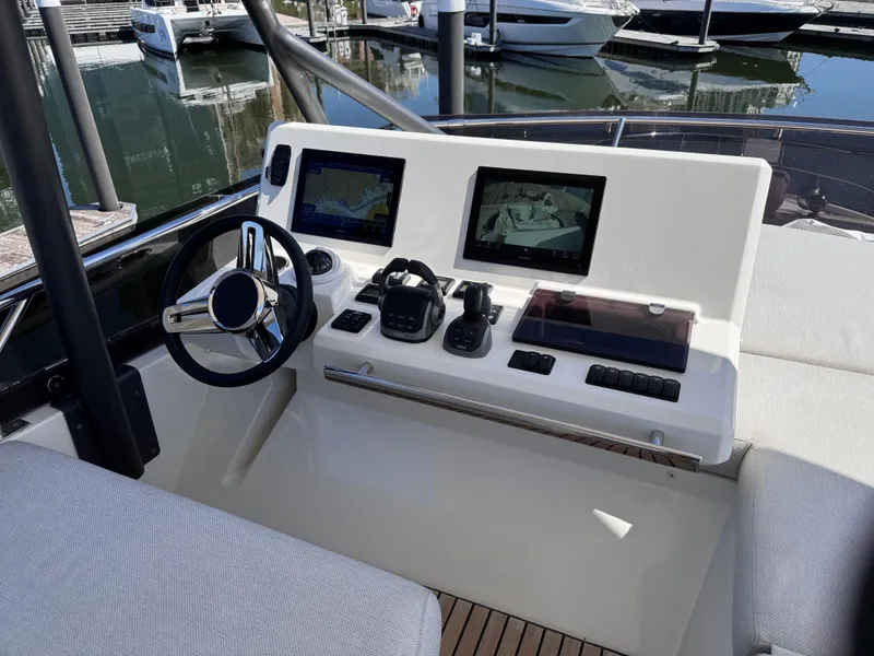 Slide: The Image of 2023 Prestige 520 F-Line yacht helm with dual screens and modern controls. - 7