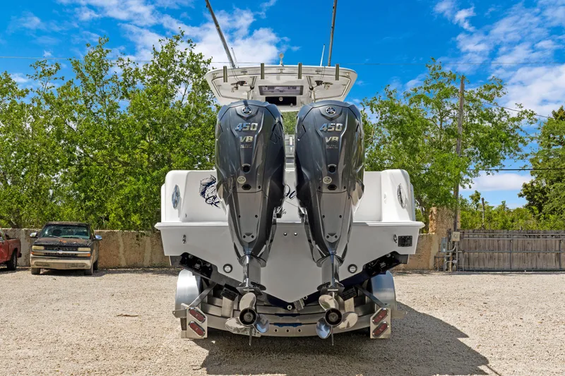 Slide: The Image of 2024 Contender 35 ST boat with dual 350 V8 engines, parked outdoors. - 1