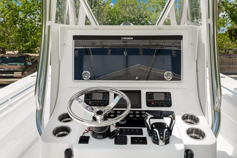Slide: The Image of 2024 Contender 35 ST boat console with steering wheel and navigation controls. - 19