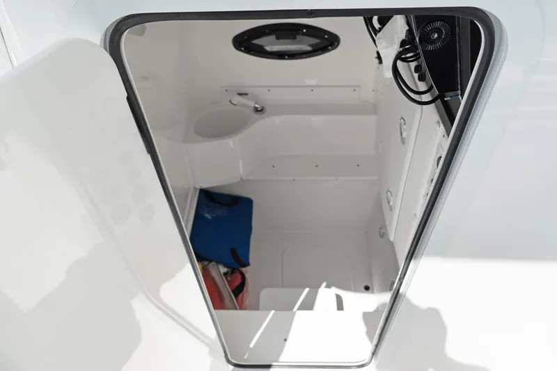 Slide: The Image of 2024 Contender 35 ST boat interior, featuring a compact cabin with storage and seating. - 28