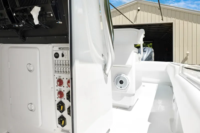 Slide: The Image of 2024 Contender 35 ST boat interior with control panel and speaker, in a sunny setting. - 29