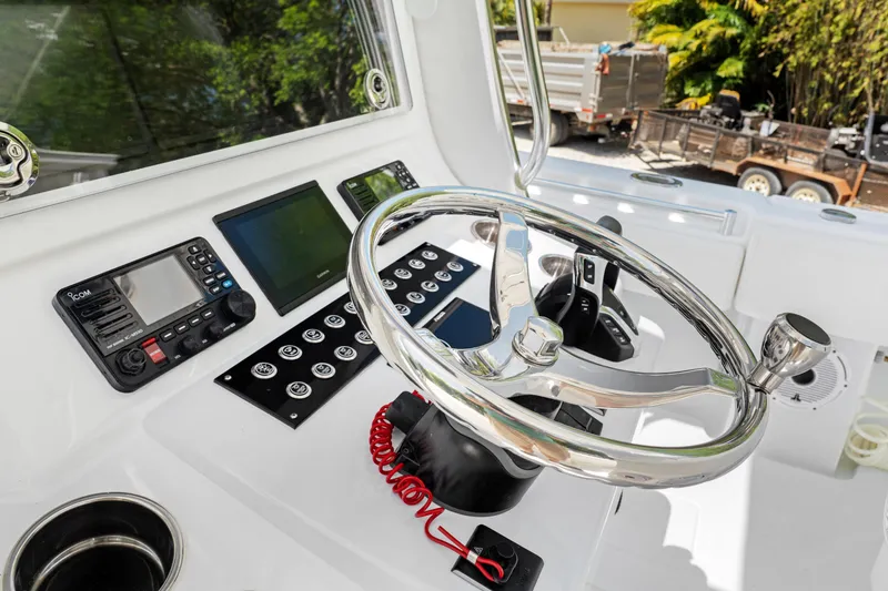 Slide: The Image of 2024 Contender 35 ST boat dashboard with steering wheel and electronic controls. - 30