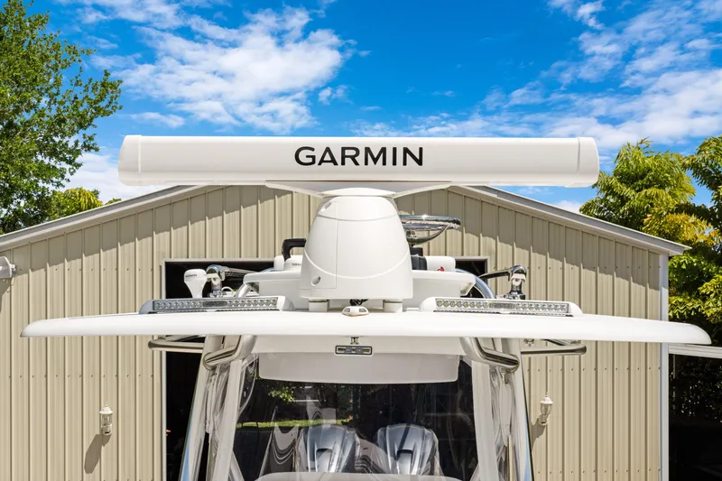 Slide: The Image of 2024 Contender 35 ST boat with Garmin radar, parked in front of a garage. - 33