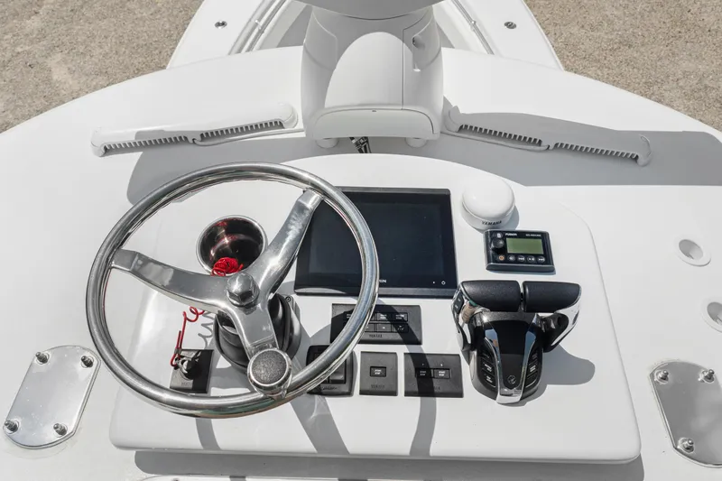 Slide: The Image of 2024 Contender 35 ST boat helm with steering wheel and control panel. - 40