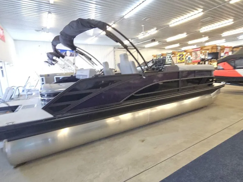 Slide: The Image of 2025 Bennington M Swingback 24 MSB pontoon boat in showroom, side view. - 1