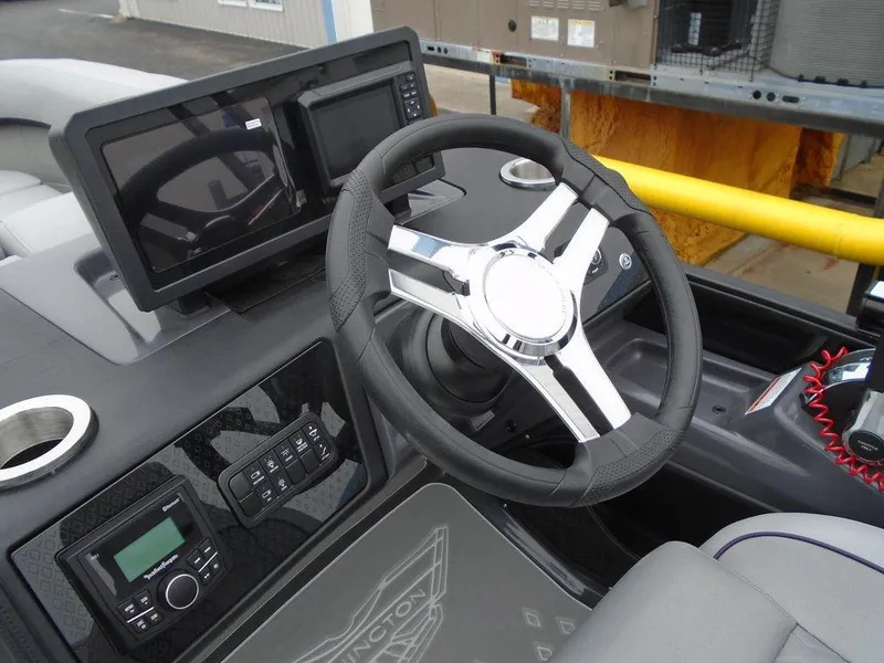 Slide: The Image of Steering console of 2025 Bennington M Swingback 24 MSB with modern controls and displays. - 11