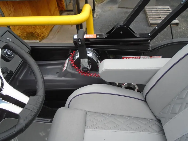 Slide: The Image of Helm of 2025 Bennington M Swingback 24 MSB with steering wheel and throttle controls. - 14