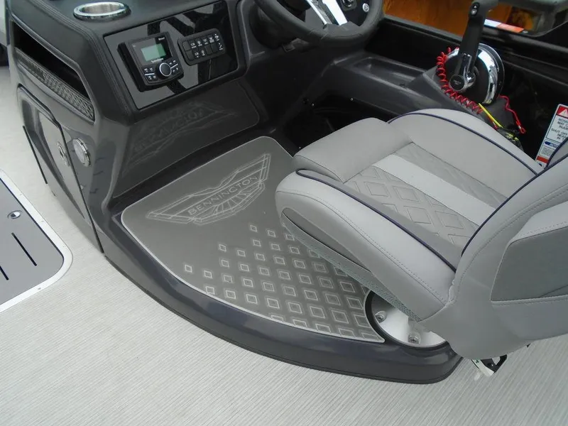 Slide: The Image of Captain's seat and console of 2025 Bennington M Swingback 24 MSB boat, featuring modern controls. - 17