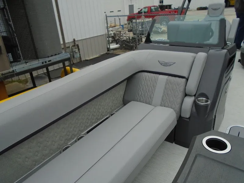 Slide: The Image of 2025 Bennington M Swingback 24 MSB boat interior with gray seating and cup holders. - 18
