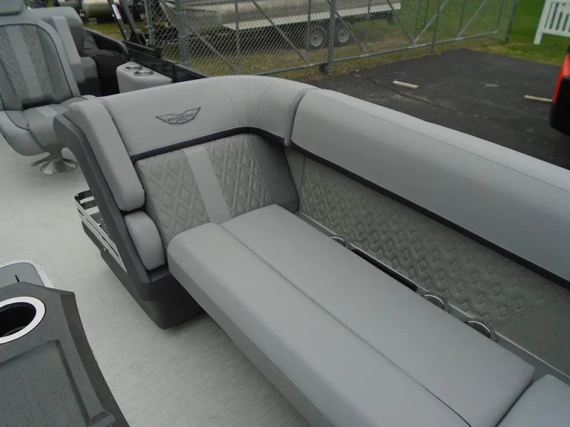 Slide: The Image of 2025 Bennington M Swingback 24 MSB boat interior with luxurious gray seating. - 19