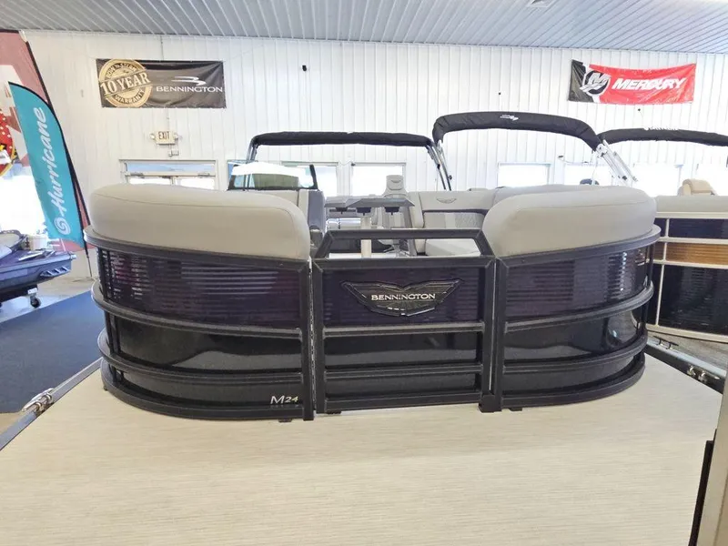 Slide: The Image of 2025 Bennington M Swingback 24 MSB pontoon boat displayed indoors. - 2