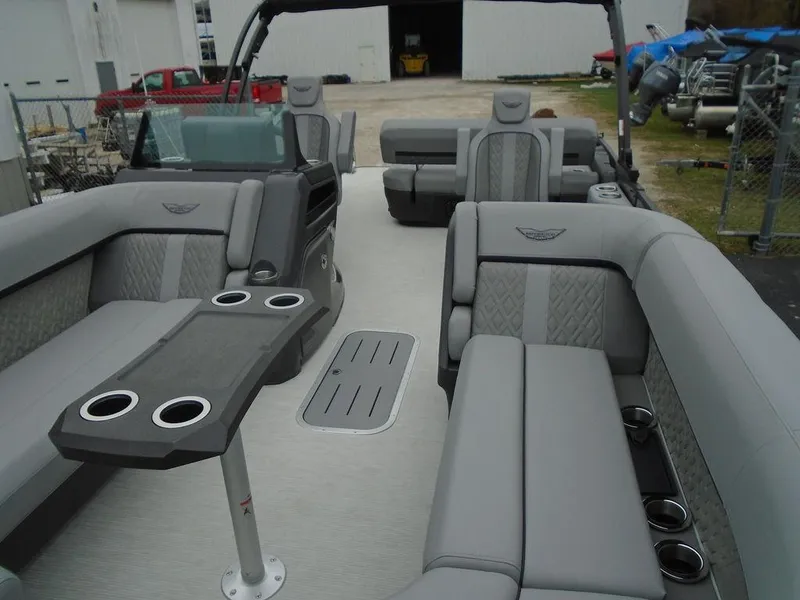Slide: The Image of 2025 Bennington M Swingback 24 MSB pontoon boat interior with luxurious seating and cup holders. - 23