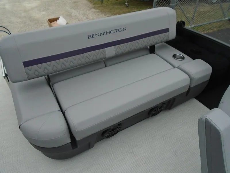 Slide: The Image of 2025 Bennington M Swingback 24 MSB boat seat, gray upholstery, cup holder, outdoor setting. - 26