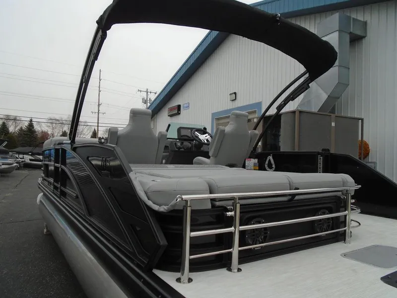 Slide: The Image of 2025 Bennington M Swingback 24 MSB pontoon boat with sleek design and comfortable seating. - 30