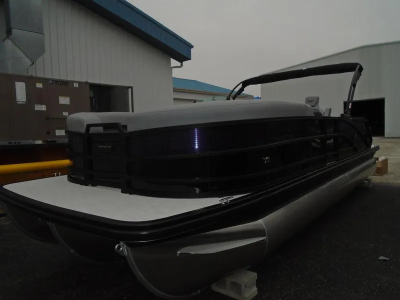 Slide: The Image of 2025 Bennington M Swingback 24 MSB pontoon boat in a storage area. - 32