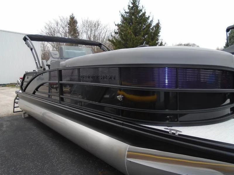 Slide: The Image of 2025 Bennington M Swingback 24 MSB pontoon boat, sleek design, docked outdoors. - 33