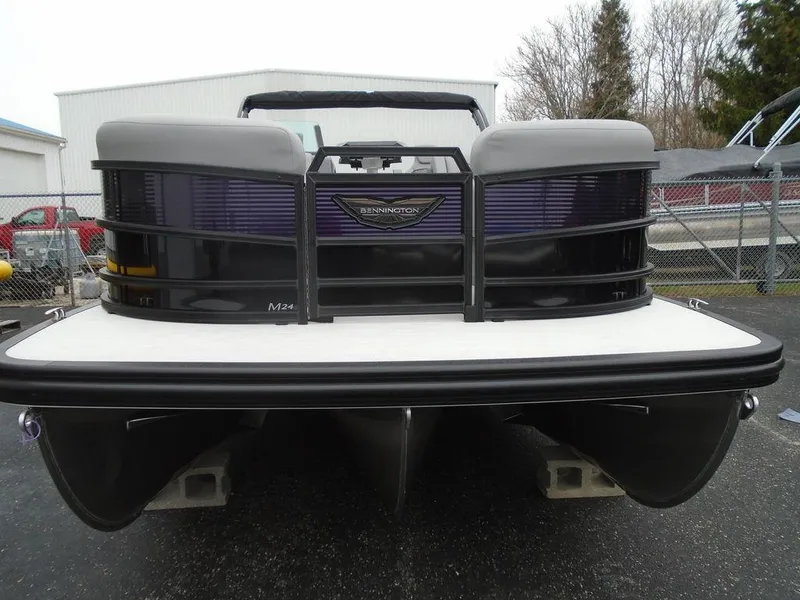 Slide: The Image of 2025 Bennington M Swingback 24 MSB pontoon boat, rear view, parked on pavement. - 35