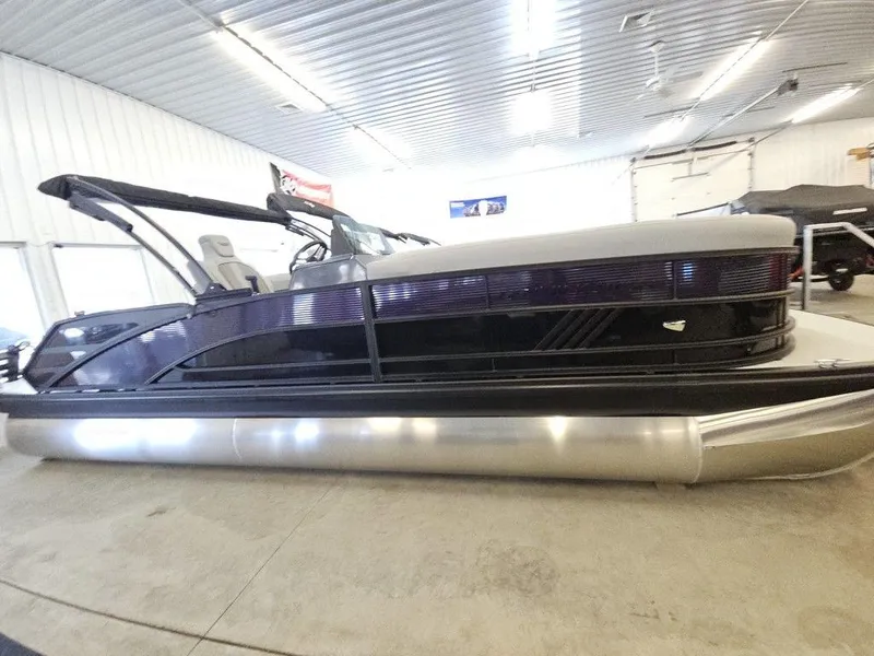 Slide: The Image of 2025 Bennington M Swingback 24 MSB pontoon boat in indoor showroom. - 4