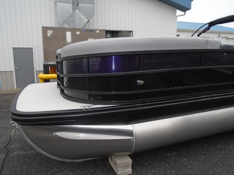 Slide: The Image of 2025 Bennington M Swingback 24 MSB pontoon boat, sleek design, docked outdoors. - 5