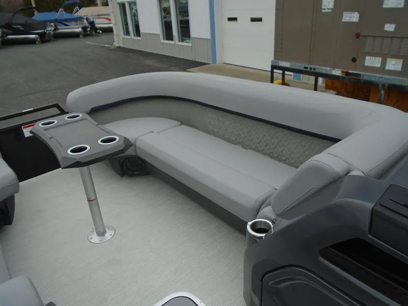 Slide: The Image of 2025 Bennington M Swingback 24 MSB pontoon boat interior with gray seating and cup holders. - 6