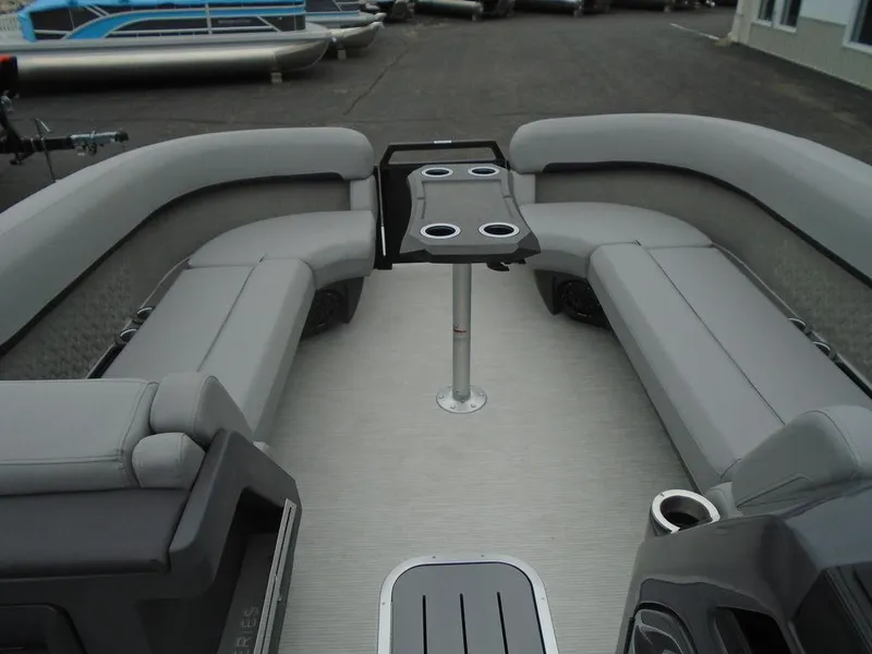 Slide: The Image of 2025 Bennington M Swingback 24 MSB pontoon boat interior with gray seating and table. - 8