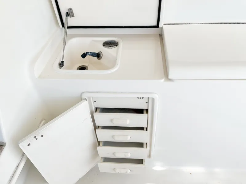Slide: The Image of 2002 Ocean Yachts 48 Super Sport interior with sink and storage drawers. - 11