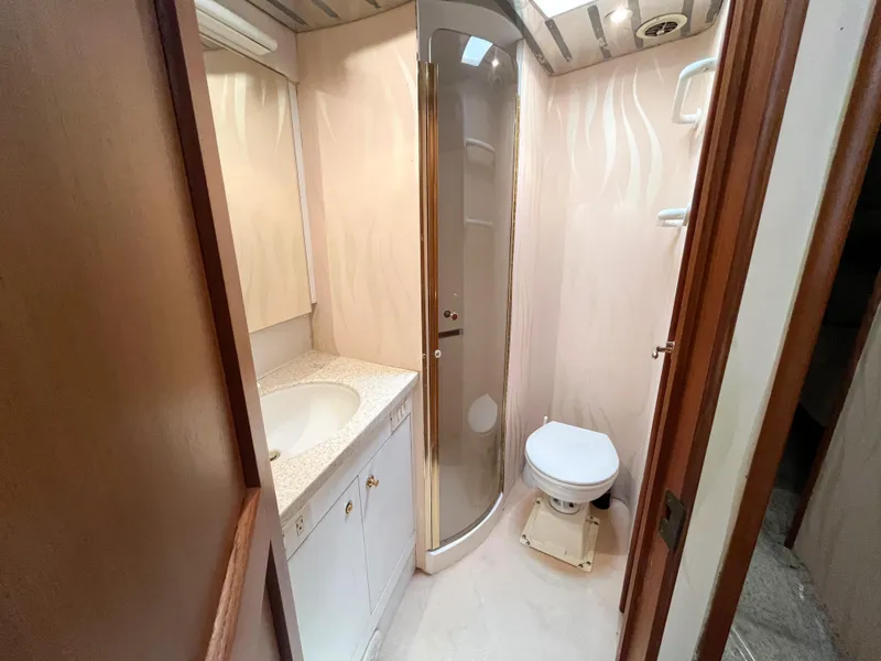 Slide: The Image of Bathroom interior of 2002 Ocean Yachts 48 Super Sport with shower, sink, and toilet. - 14
